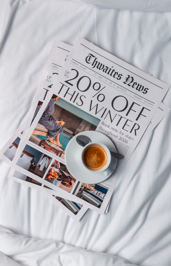 'up to 20% off' newspaper and coffee on bed